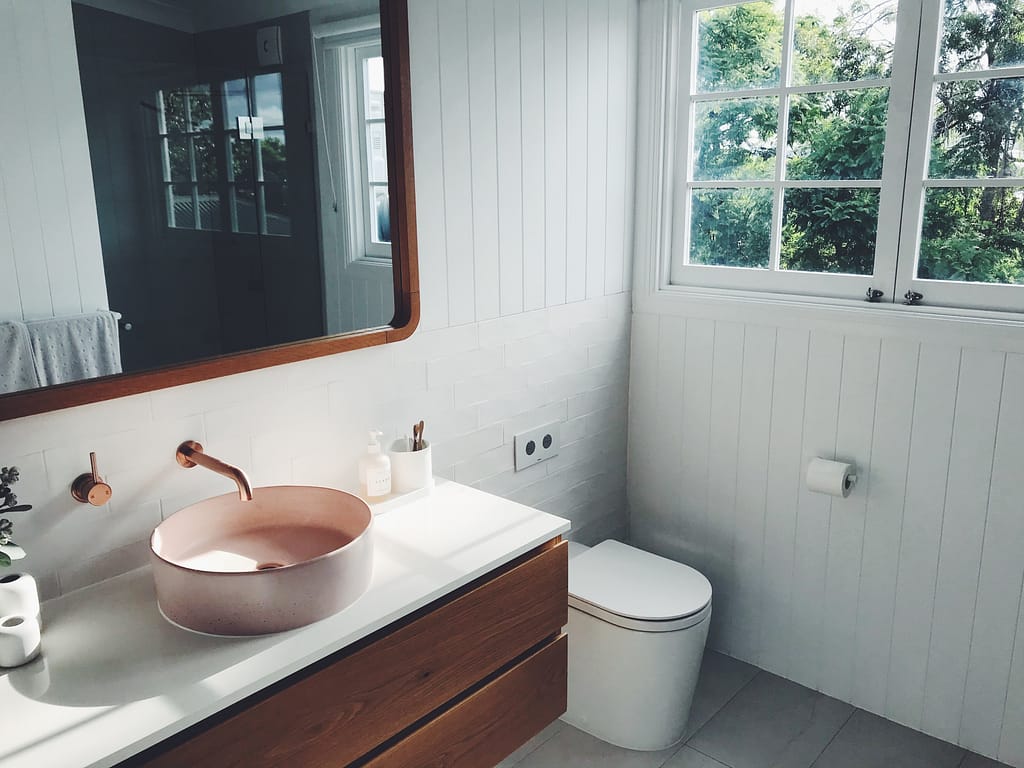 Renovated bathroom blush pink stone basin and oak finishes cameron smith ctxnvsiwzbw unsplash